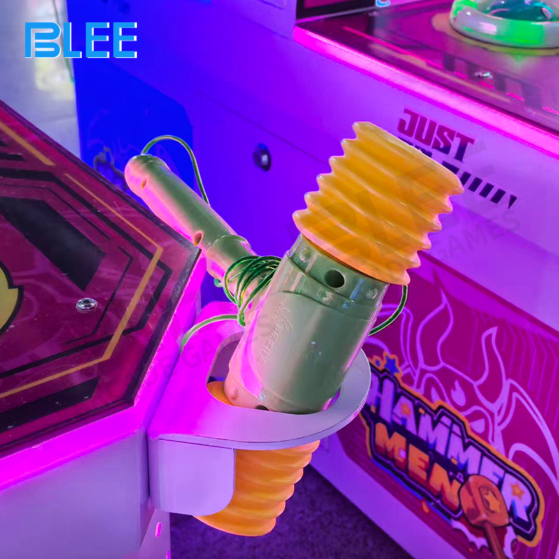 Child using soft mallet to play the whack-a-mole game with a smiling expression