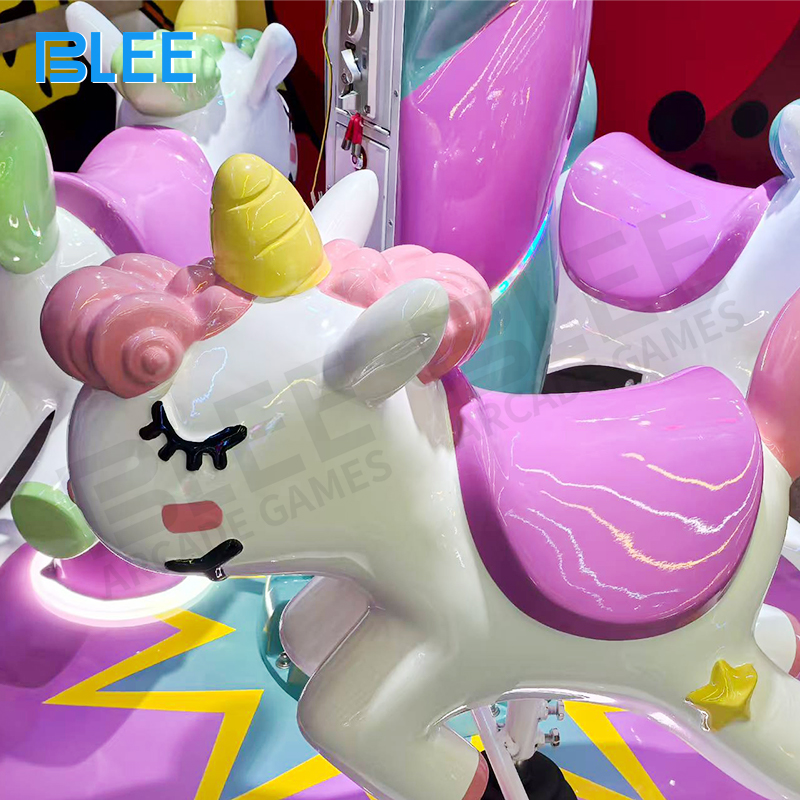 Three children riding together on the rotating platform with joyful expressions