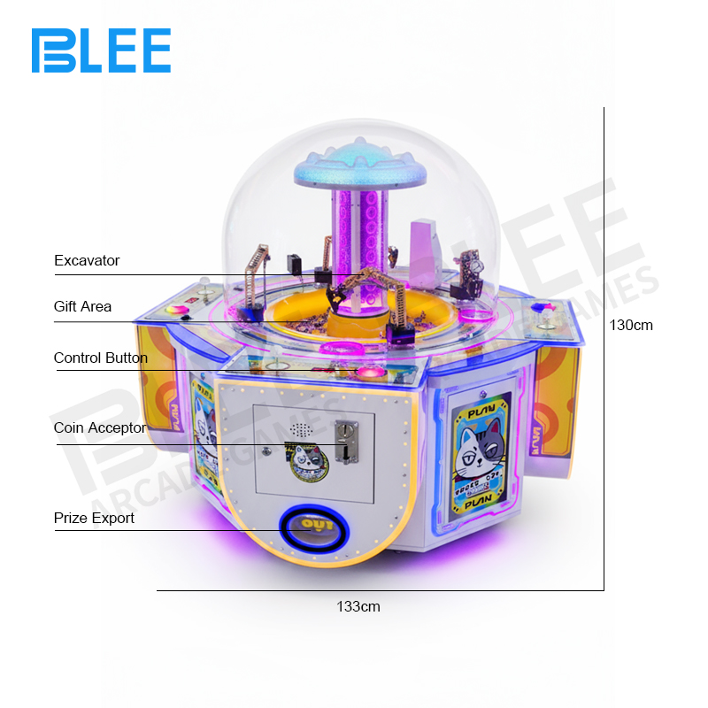 On-screen excavator arm successfully grabbing a prize from the digital sandbox