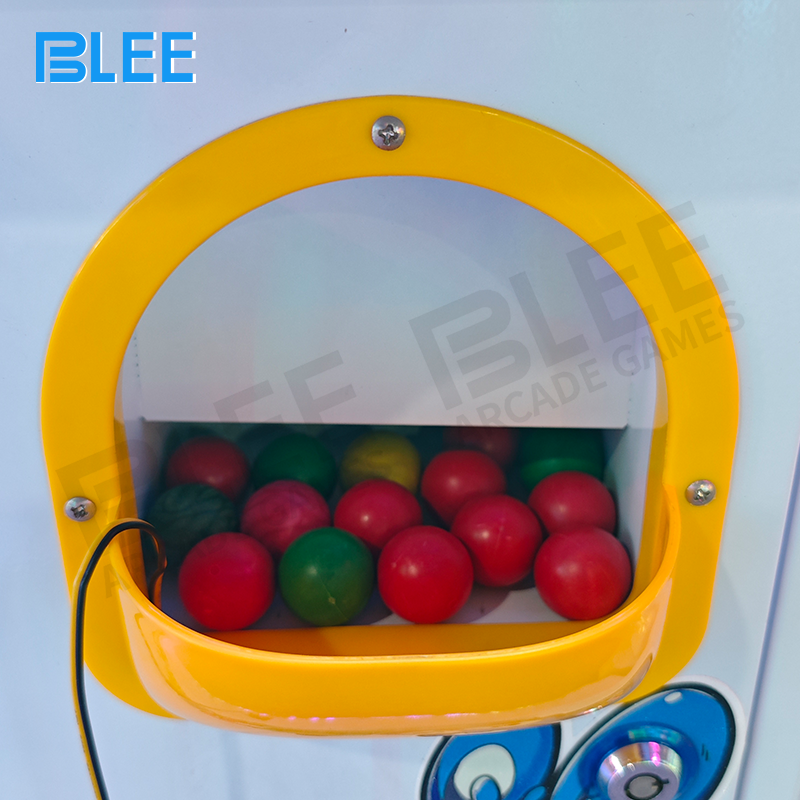 Control panel close-up highlighting simple coin operation and fire button