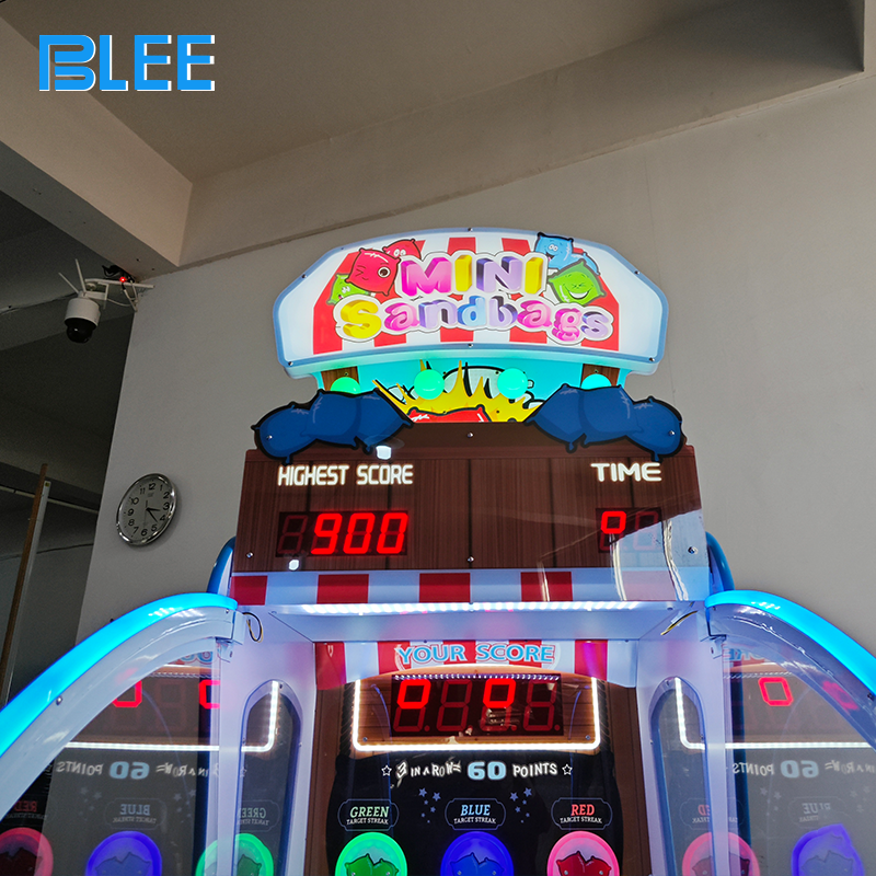 Family group enjoying competitive sandbag throwing gameplay session on BLEE redemption machine in entertainment venue