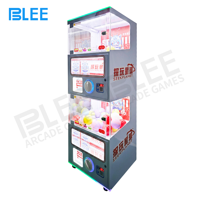 dual capsule dispenser Two customers receiving simultaneous capsule prizes from both machine stations