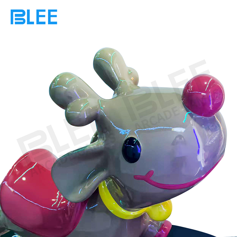 Child listening to music through integrated speakers while rocking on the deer-shaped seat