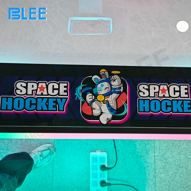 Control panel close-up featuring coin mechanism, start buttons, and game duration settings
