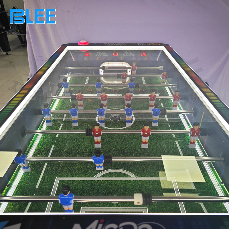 The game's simple control panel with a start button and coin indicator lights.