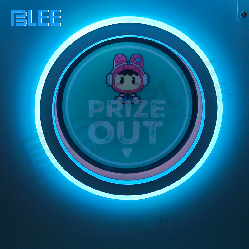 Close-up view of the vibrant clown-themed cabinet and prize compartment of the claw machine.