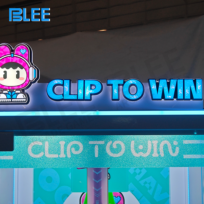 Overhead view of the claw mechanism and gift items inside the prize redemption machine.