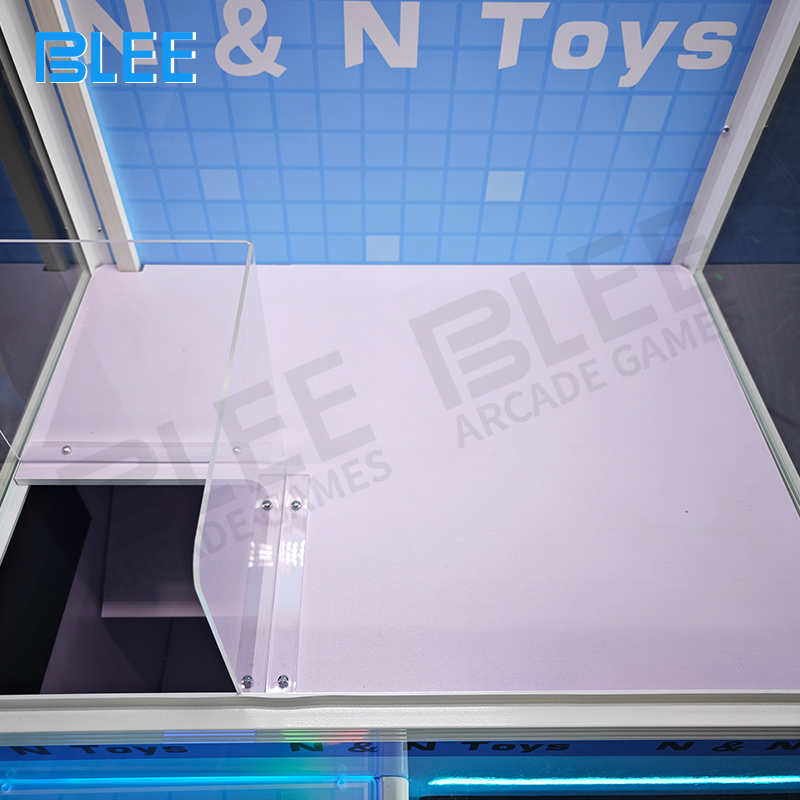 Interior view showing claw mechanism and prize arrangement within the wooden crate structure