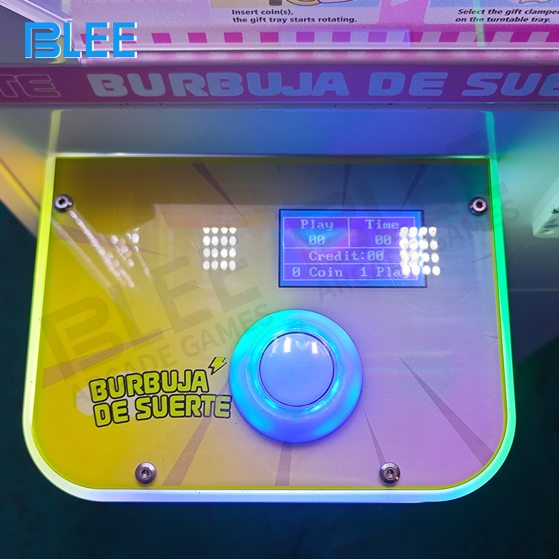 Close-up of the oversized claw mechanism suspended above premium plush toy prizes.