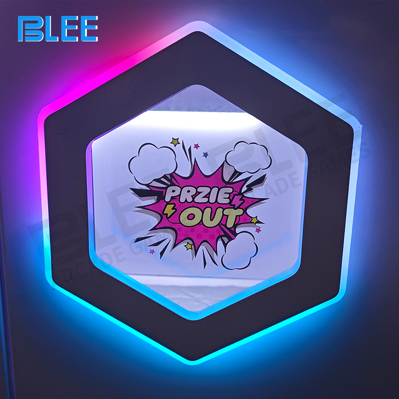 Player operating the heavy-duty joystick and control buttons on the giant crane machine.