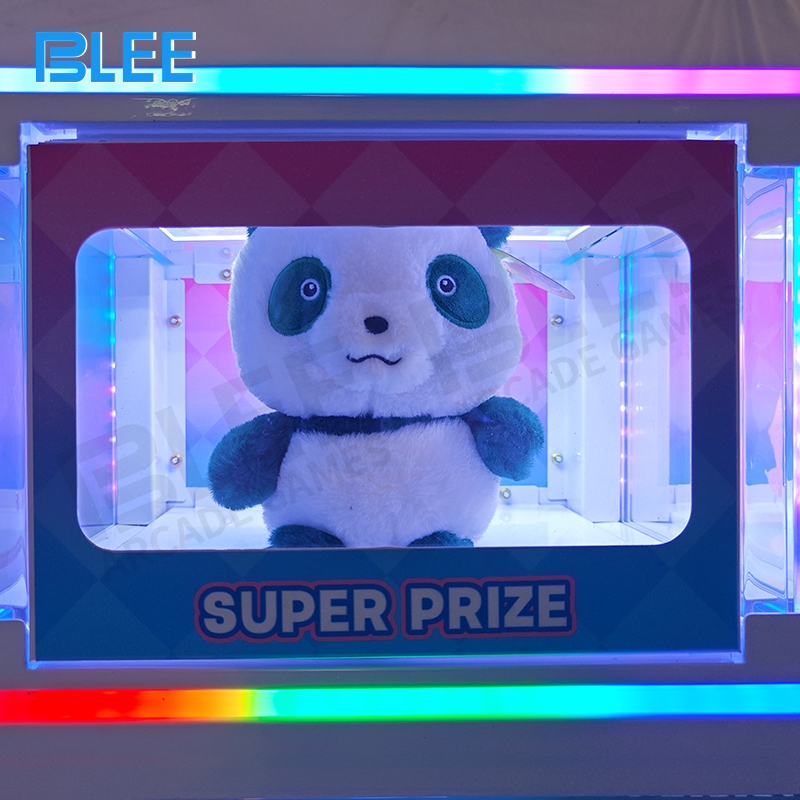 Player turning the dispensing mechanism to receive a themed capsule prize