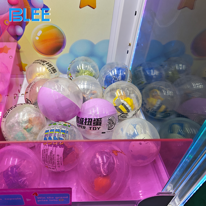 Capsule dispensing mechanism in action delivering surprise collectible toys