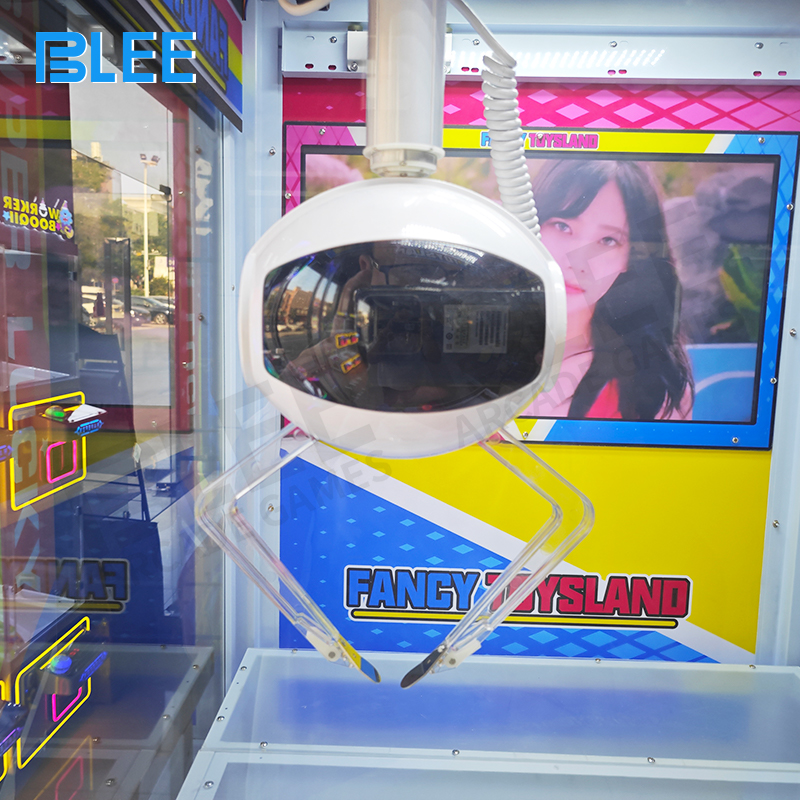 Player controlling both claw joysticks for coordinated prize capture strategy