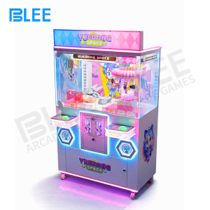 Illuminated play area with LED lighting enhancing both claw operation zones