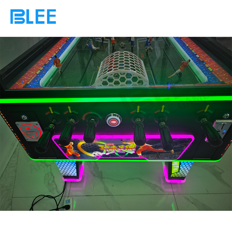 The digital display screen showing a live game with a countdown timer, score (e.g., 2-1), and session stats.