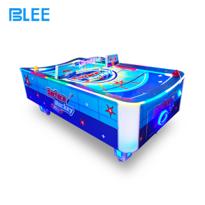 Two players engaged in competitive battle, using mallets to strike the puck toward goals.