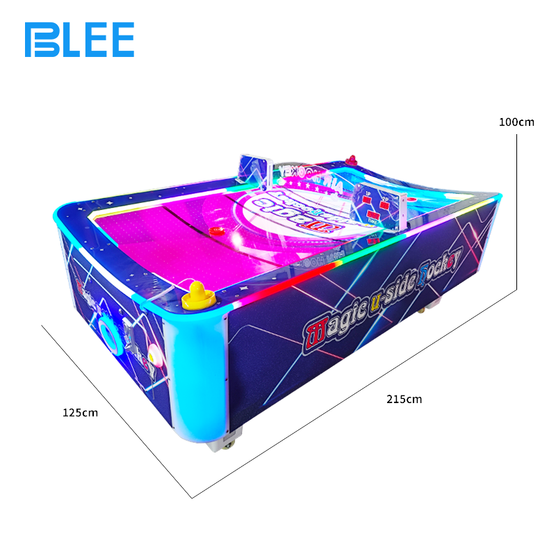 Two players engaged in competitive battle, using mallets to strike the puck toward goals.