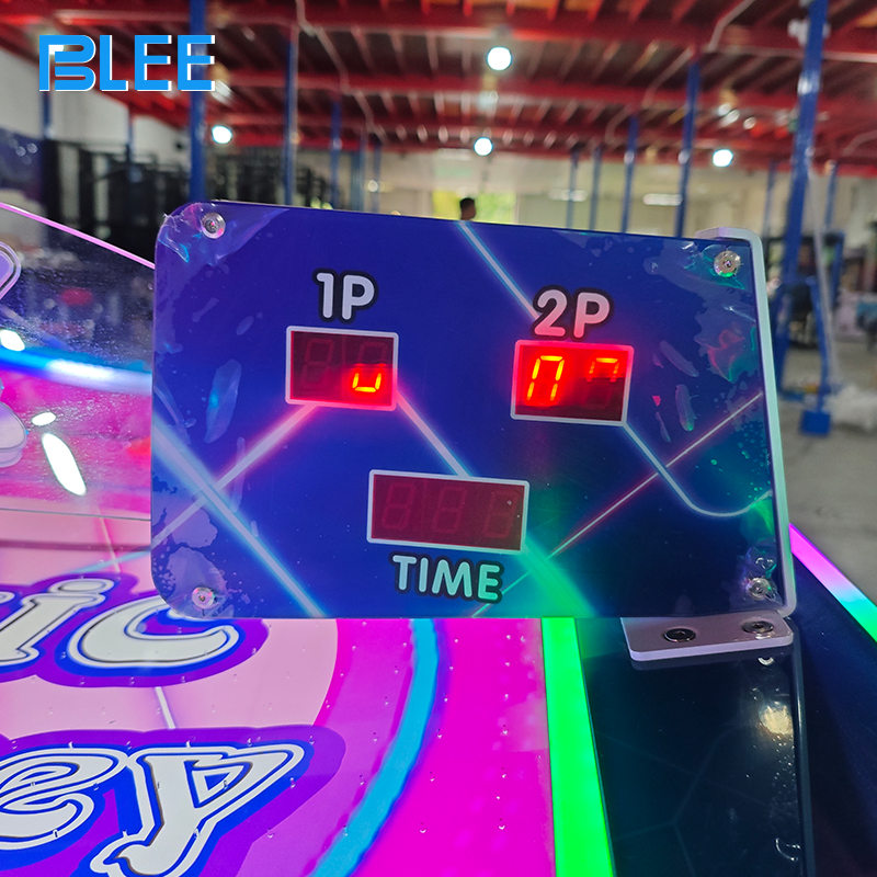 Close-up of a player scoring a goal as the puck enters the opponent's goal slot.