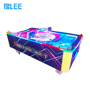 Player inserting coins into the payment slot to activate gameplay.