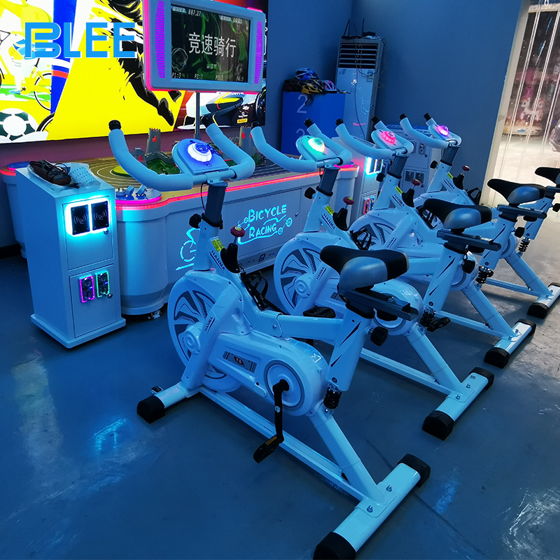 Close-up of exercise bike showing resistance adjustment and speed sensors.