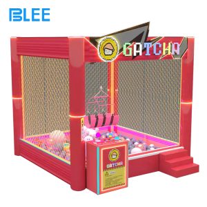 BLEE Real-Life Claw Machine with large transparent pit and lifting harness in a busy family entertainment center.