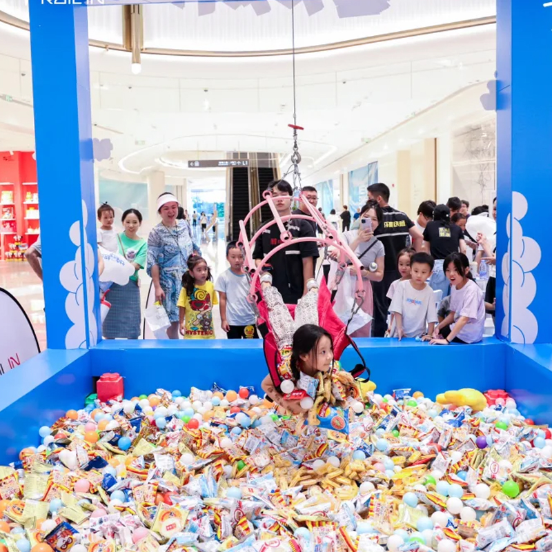 Close-up of the secure lifting mechanism with emergency stop button and harness attachment points.