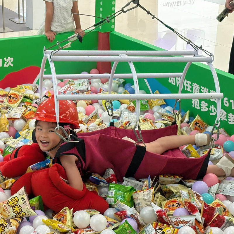 Crowd cheering as a player successfully grabs a large prize from the pit floor.